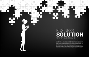 businesswoman with mobile phone and jigsaw piece to fit together. online business concept of solution and business matching.