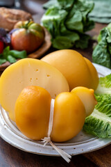 Cheese collection, Italian cheeses provolone, caciocavallo, scamorza made from sheep or cow milk in South Italy, white and yellow smoked.