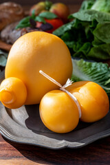 Cheese collection, Italian cheeses provolone, caciocavallo, scamorza made from sheep or cow milk in South Italy, white and yellow smoked.