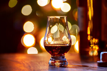 Glasses of scotch whisky served in bar in Edinburgh, Scotland, UK and pasry lights on background - obrazy, fototapety, plakaty