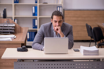 Young male employee working in the office