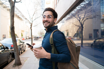 Fototapeta na wymiar Young man using his mobile phone outdoors.