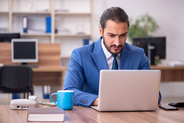 Young male employee working in the office