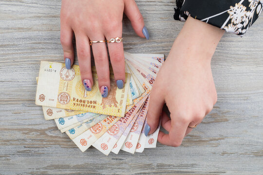 Female hands with Moldovan money. MDL Moldavian Lei. Abstract background on the theme of expenses or income.