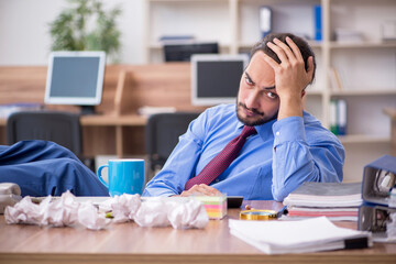 Young male employee in brainstorming concept