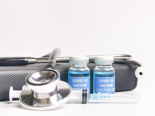 Selective focus image Covid 19 vaccines with stethoscope,syringe and book.