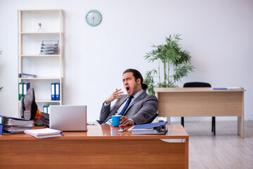 Young male employee working in the office