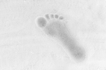 Trail from one man's foot on white beach sand background