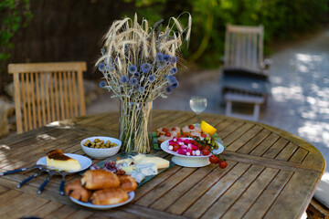 Breakfast on the table in the yard in the summertime