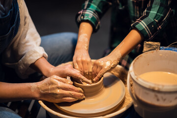 the older sister and her younger brother spend time in a pottery workshop, making clay dishes