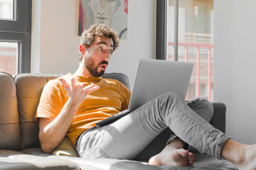 young bearded man open-mouthed and amazed, shocked and astonished with an unbelievable surprise...