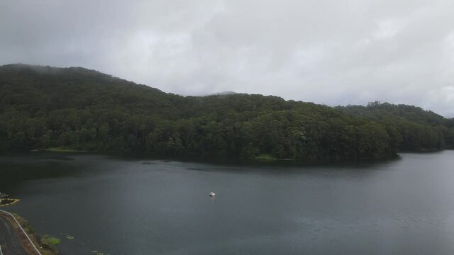 Calm Water At Karangi Dam With Overcast And Fog - Lake In Karangi, Coffs Harbour, NSW, Australia. - aerial