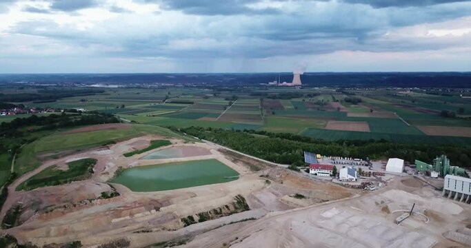 Gravel pit against nuclear power plantain on the horizon, Essenbach, Bavaria, Germany