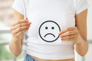 Stop smoking, young woman holding a cigarette