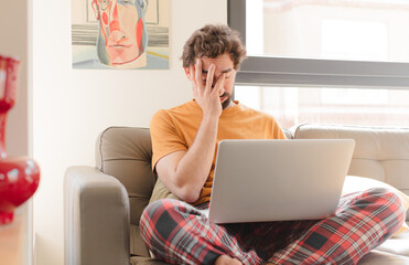 young bearded man feeling bored, frustrated and sleepy after a tiresome, dull and tedious task,...