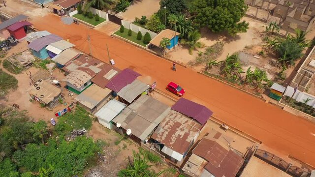 Aerial dirt road Accra Ghana residential neighborhood 4K. West Africa on the Atlantic ocean. Summer residential area with dirt streets, homes, houses, apartments and business. Crowded neighborhood