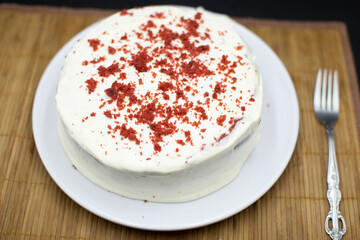 Delicious homemade red velvet cake with fresh berries on black background