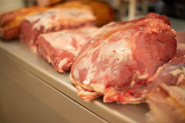Variety of raw cuts of meat, dry aged beef steaks and hamburger patties