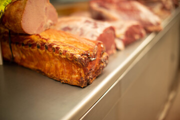 Variety of raw cuts of meat, dry aged beef steaks and hamburger patties