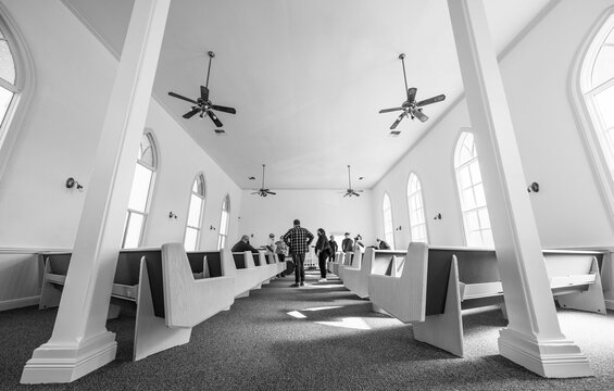 A black and white photo of the interior of a historic church
