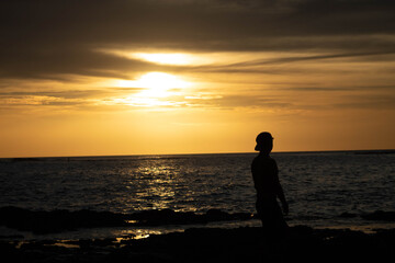 silhouette of a person at sunset