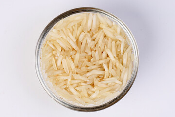 Medium grain jasmine rice in glass bowl on white background