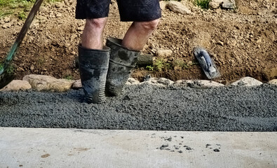 pouring of concrete for a driveway.leg view