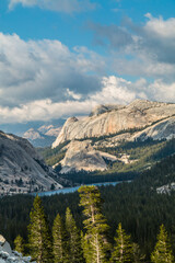 Obraz premium majestic summer views of granite rock formations and the Half Dome as viewed from Olmstead Point near Tioga Pass in Yosemite, California.