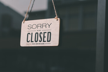 Vintage sorry we are closed at the glass door of a coffee shop, restaurant, shop, during the outbreak of the virus protection. 