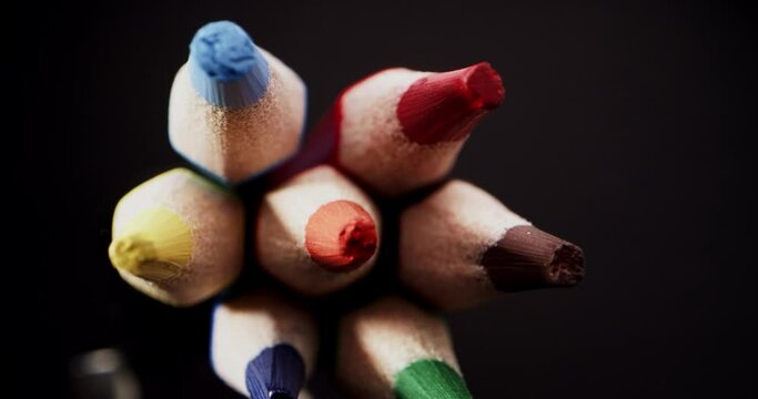Unique macro probe of colorful pencils details on black background. close-up pov
