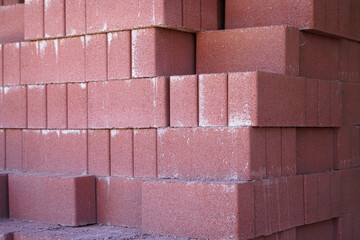 close up on red brick wall stacking in pile in construction site