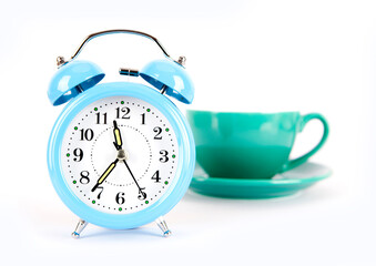 Fototapeta na wymiar Blue alarm clock and a cup of coffee