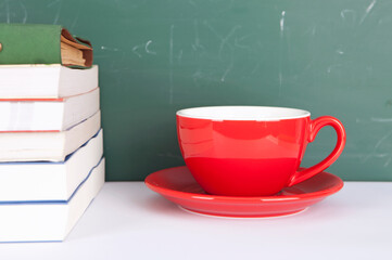 A cup of coffee and a pile of books