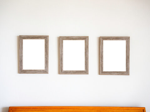 Three blank vintage wooden picture frames.
