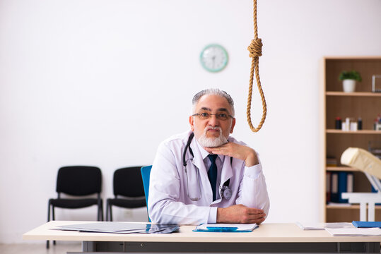 Old male doctor committing suicide at workplace