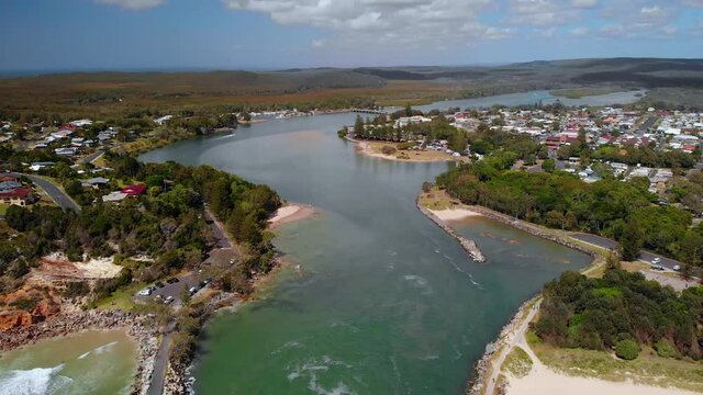 Aerial view away from the Evans Head town, sunny day - pull back tilt drone shot