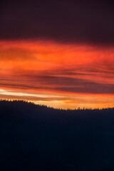 red fiery sky and dark clouds cover the summer Yosemite sky due to a forest fire.