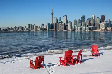 Tuinposter Red Muskoka Chairs with Toronto Skyline and Frozen Lake Ontario in Winter © Muskoka