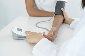 Female doctors measured blood pressure, the patient examined the heartbeat and talked about health...