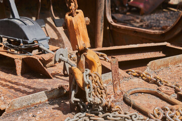 Side View Reel and Chain and U Bolt and Automatic Gear Handle on Rusty Old Car Interior