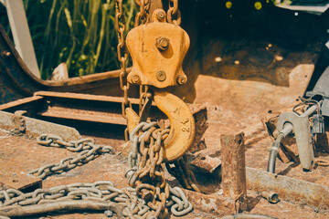 Front View Reel and Chain and U Bolt on Rusty Old Car Interior in Vintage Tone