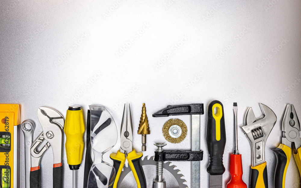 Wall mural different work tools on gray metal surface. view from above. industrial background