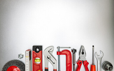 set of hand tools and instruments for home renovation or DIY on grey workbench with copy space