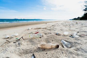 Fototapeta na wymiar Dirty sea sandy shore ,Environmental pollution, Plastic water bottles pollution in ocean 