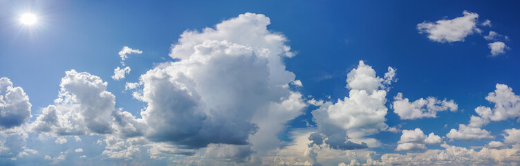Fototapeta na wymiar Dramatic white clouds on blue sky