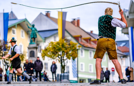 Bad Toelz, Germany - November 6: coachman with traditional clothes and popping whip at the annual leonhardifahrt procession on November 6, 2019 in bad toelz, germany