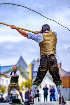 Bad Toelz, Germany - November 6: coachman with traditional clothes and popping whip at the annual leonhardifahrt procession on November 6, 2019 in bad toelz, germany