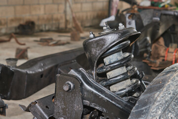 Back View Shock Absorber and Coil Spring and Upper Arm Ball Joint and Car Chassis and Tire