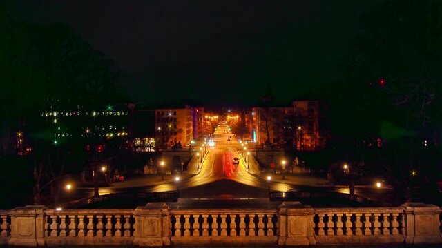 Timelapse of night traffic in Munich, germany from a higher perspective. Driving cars are starting and stopping at traffic lights - speeded up night scenes.