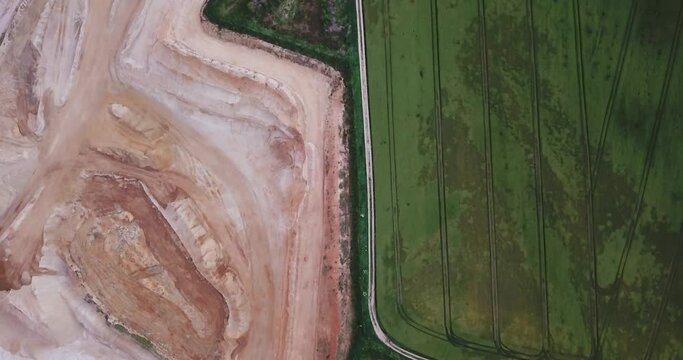 Contrast between green field and gravel pit, Essenbach, Bavaria . Environmental issues  concept